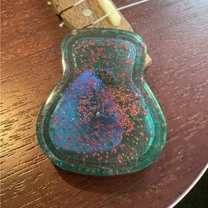 Handmade resin guitar pick case with pick.